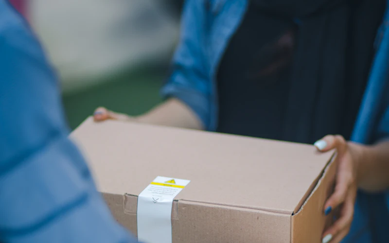 A courier handing over a parcel