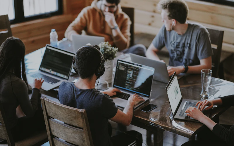 A startup team working together on laptops